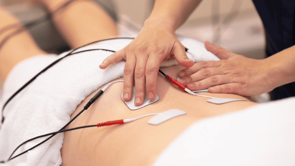 image of a person using a muscle stimulator for lower back pain