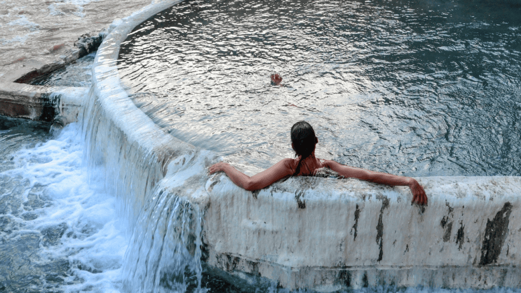woman cold plunging in outdoor river
